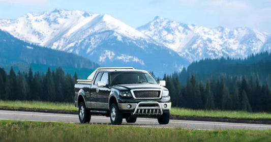 A crate holds rows of machined metal wheel hubs with circular holes, with large gears visible along the bottom edge.
