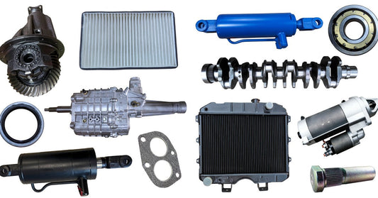 Multiple spare metal vehicle parts of different sizes and shapes, placed next to each other over a white background.