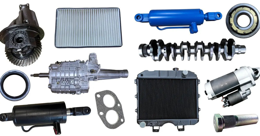 Multiple spare metal vehicle parts of different sizes and shapes, placed next to each other over a white background.