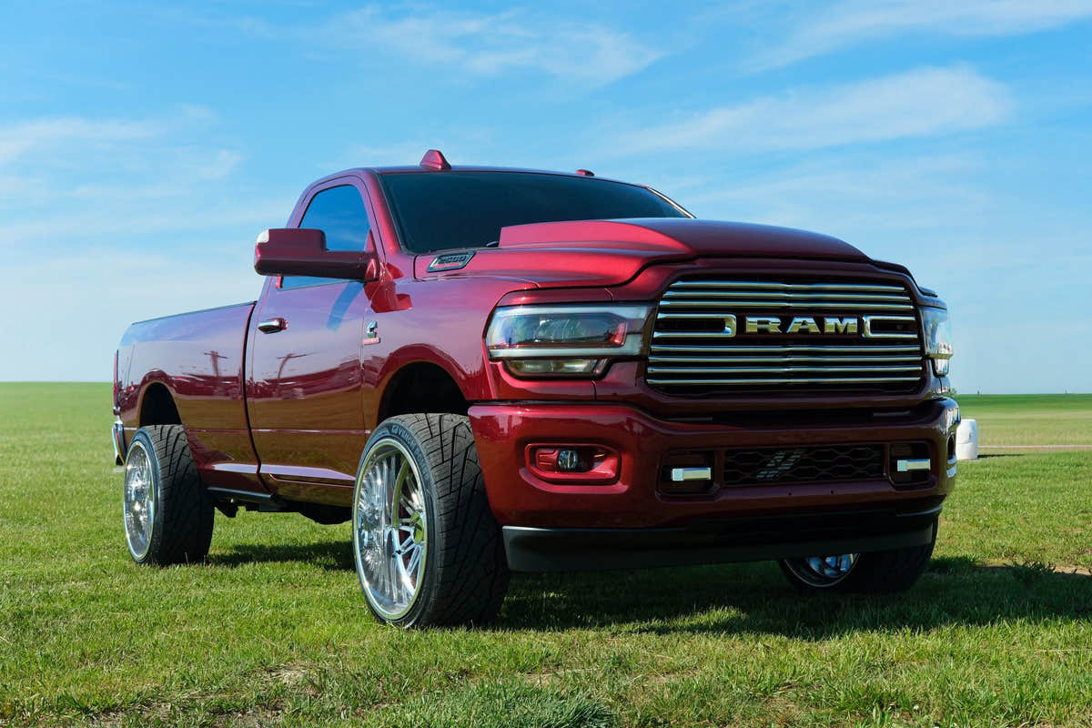 Red Ram diesel truck parked on grass under a clear blue sky